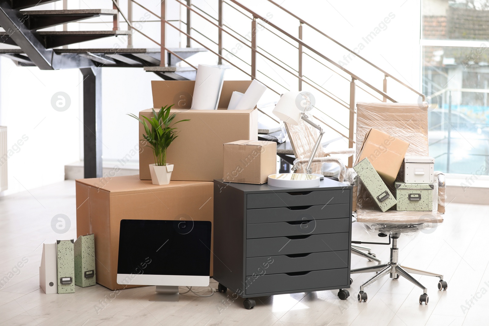 Photo of Moving boxes and furniture in new office