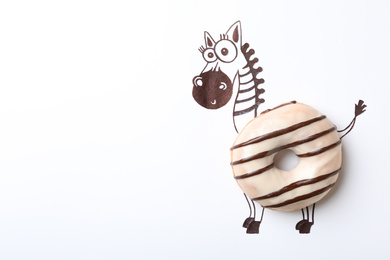 Photo of Funny zebra made with donut on white background, top view. Space for text