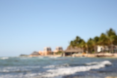 Blurred view of tropical beach and sea on sunny day