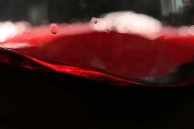 Photo of Delicious red wine in glass as background, closeup