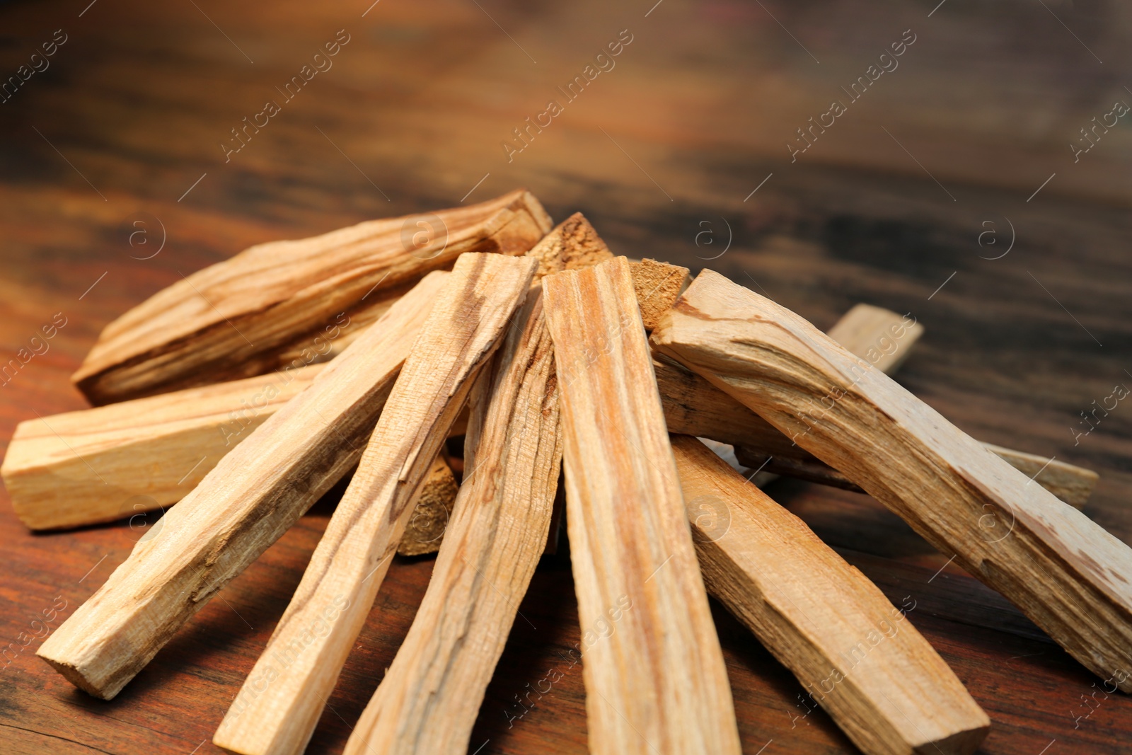 Photo of Many palo santo sticks on wooden table, closeup