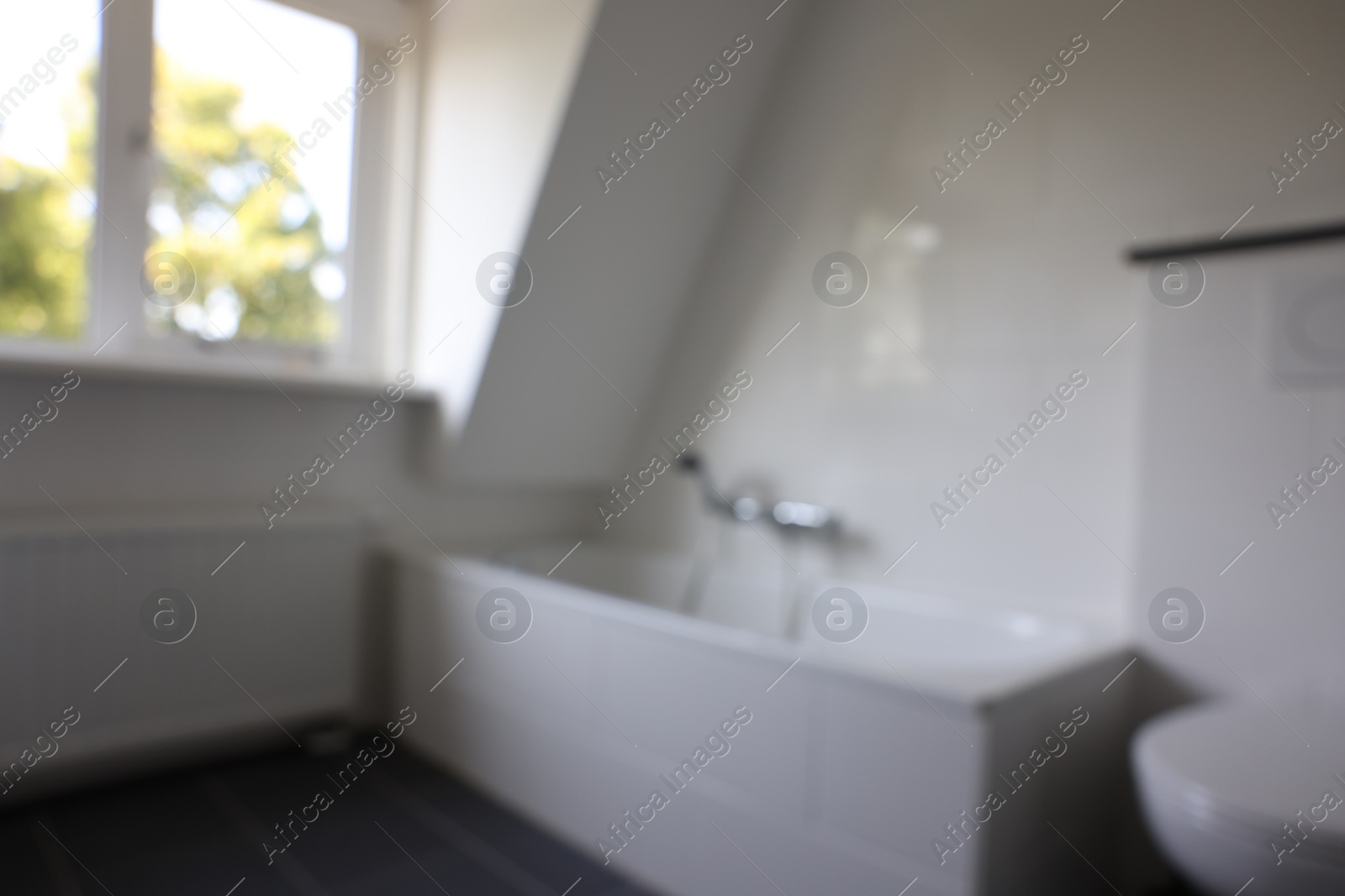 Photo of Blurred view of tub in white bathroom. Interior design