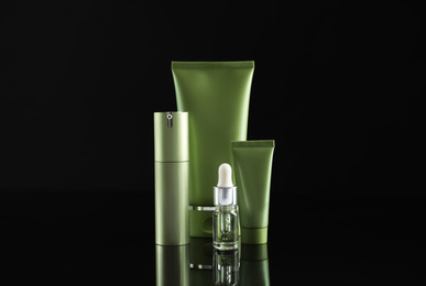 Photo of Set of cosmetic products on black background