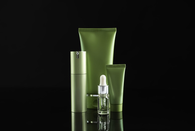 Set of cosmetic products on black background