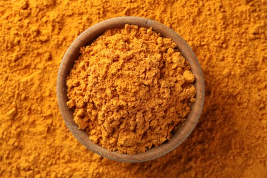 Photo of Aromatic turmeric powder and bowl, top view