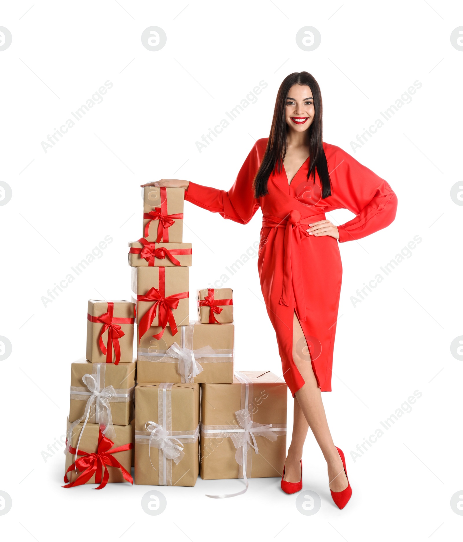 Photo of Woman in red dress with Christmas gifts on white background