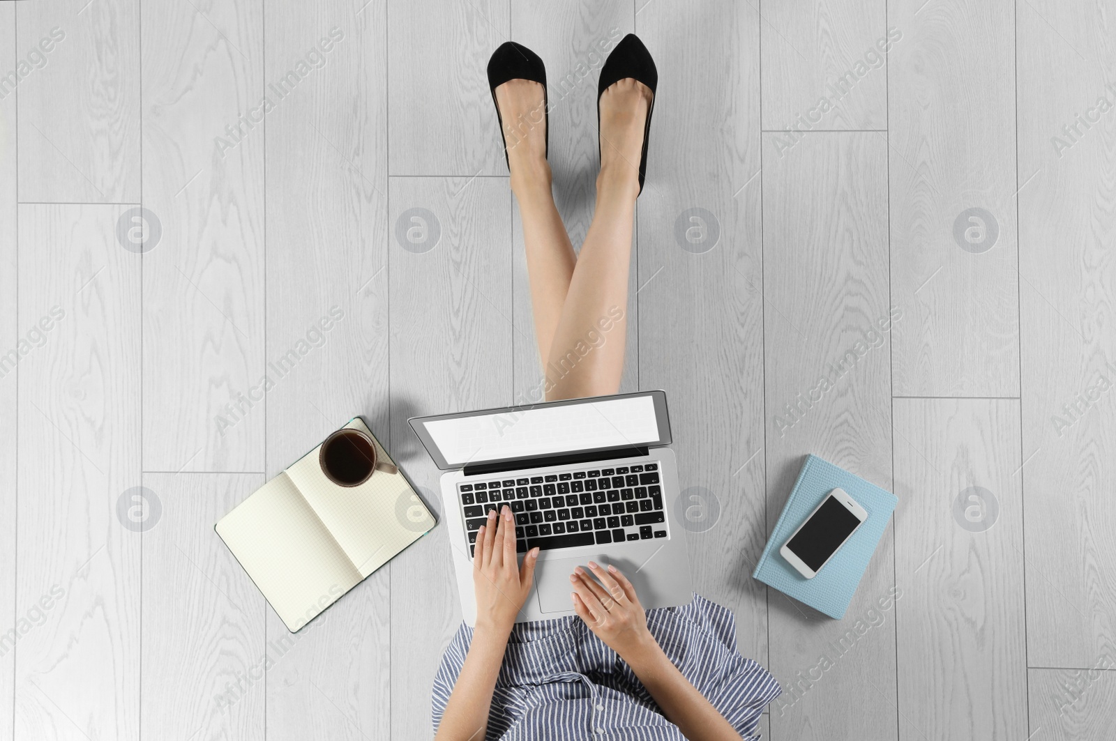 Photo of Top view of woman with laptop sitting on floor, closeup. Mockup for design