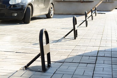 Photo of Parking barriers on pavement near car outdoors