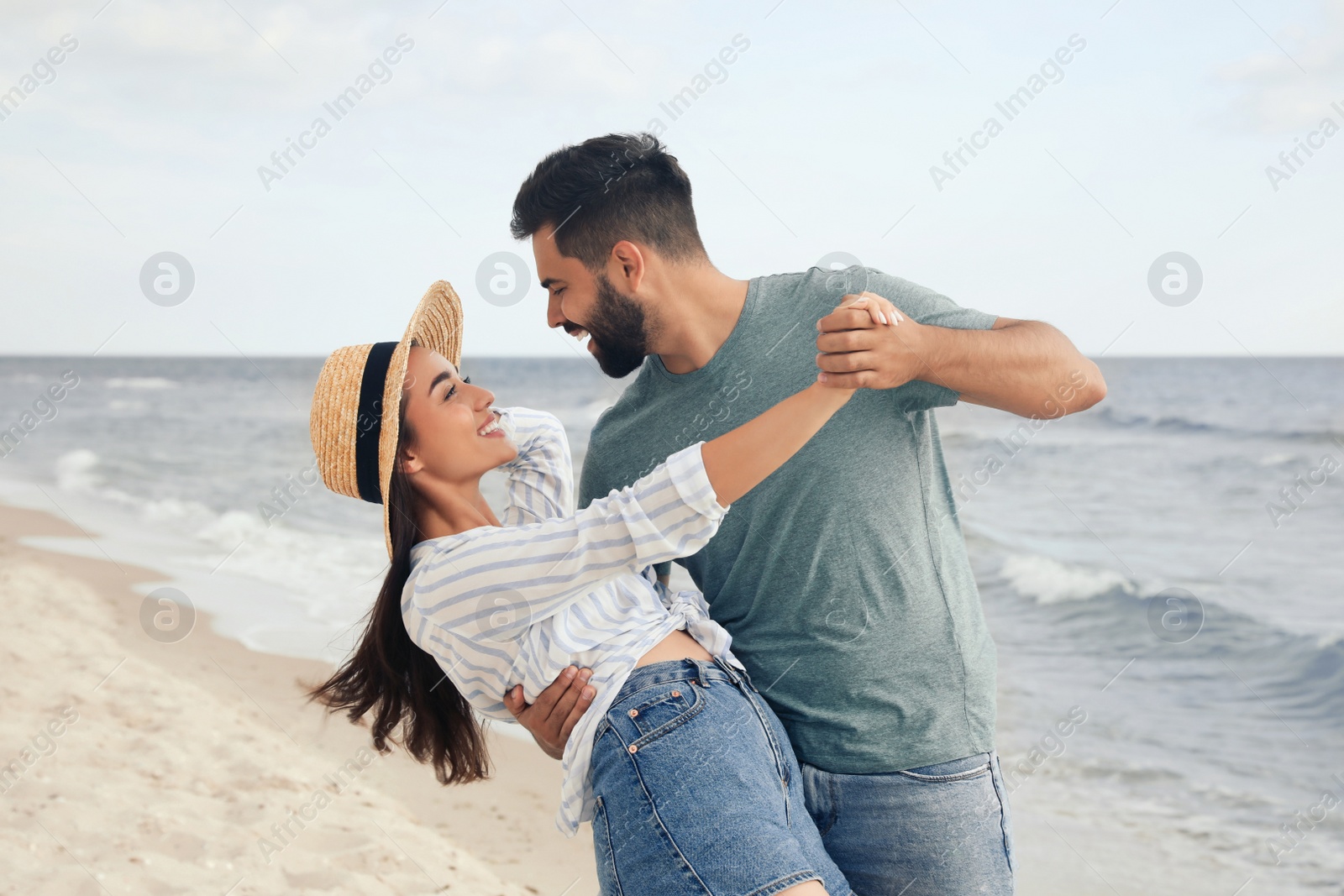 Photo of Lovely couple dancing on beach. Time together