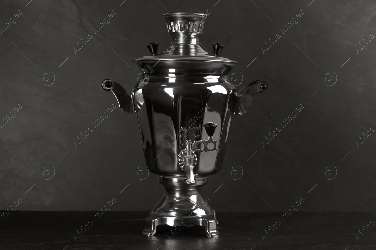 Photo of Traditional Russian samovar on dark background. Kitchenware