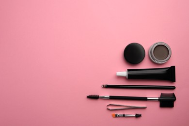 Flat lay composition with eyebrow henna and tools on pink background. Space for text