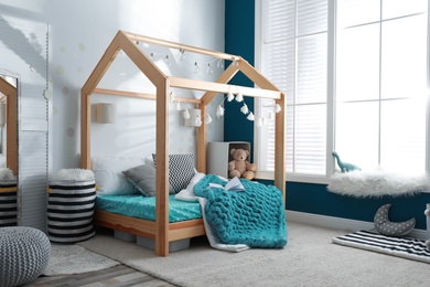 Photo of Cozy child room interior with comfortable bed