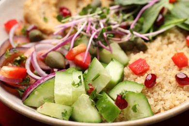 Photo of Delicious vegan bowl with cucumbers, spinach and bulgur, closeup