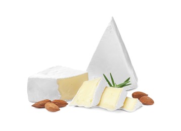 Photo of Tasty cut brie cheese with rosemary and almonds on white background