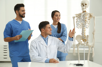 Photo of Professional orthopedist teaching medical students in clinic