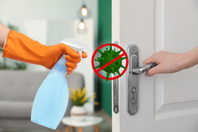 Image of Sanitizing surfaces during coronavirus outbreak. Woman opening door, closeup