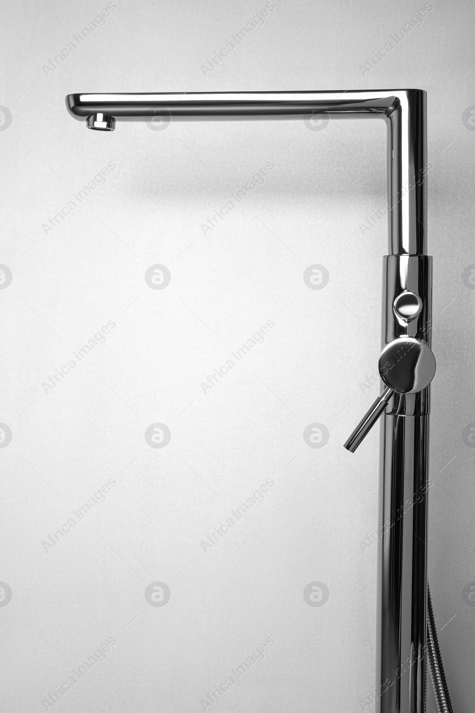 Photo of Modern single handle bathtub faucet on light grey background