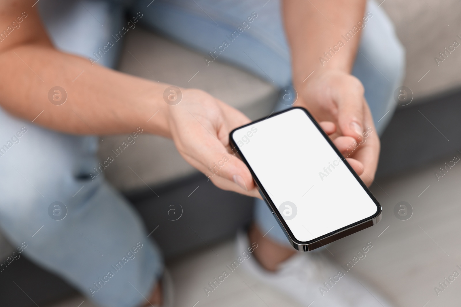 Photo of Man using mobile phone indoors, closeup view