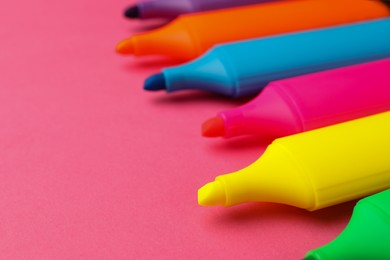 Bright color markers on pink background, closeup. Space for text