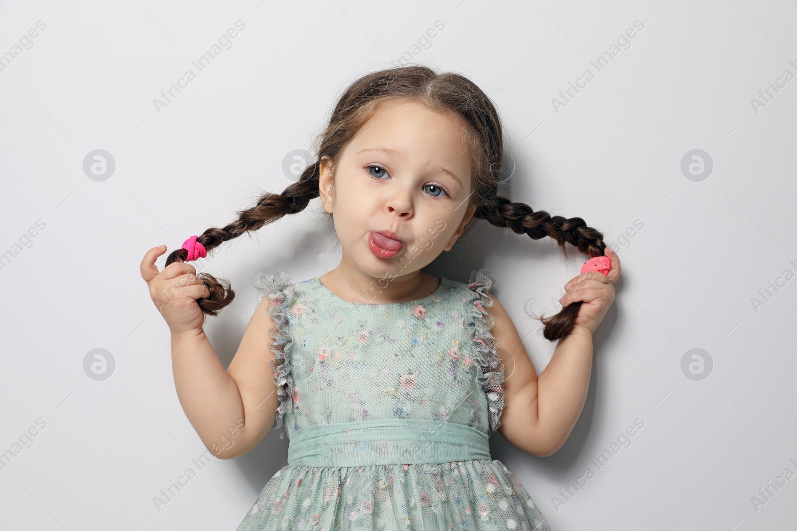 Photo of Cute little girl on light grey background