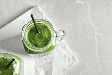 Photo of Mason jars with delicious detox juice on table, top view