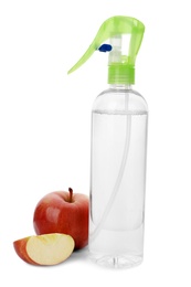 Photo of Bottle of air freshener and apple on white background