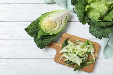 Photo of Flat lay composition with fresh green savoy cabbages on white wooden table