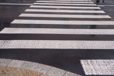 Photo of Pedestrian crossing in city outdoors after rain
