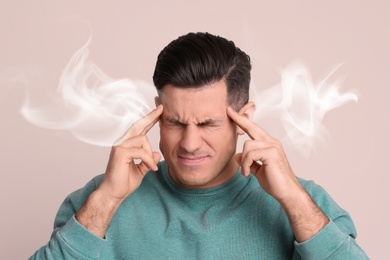 Image of Stressed and upset young man on light background