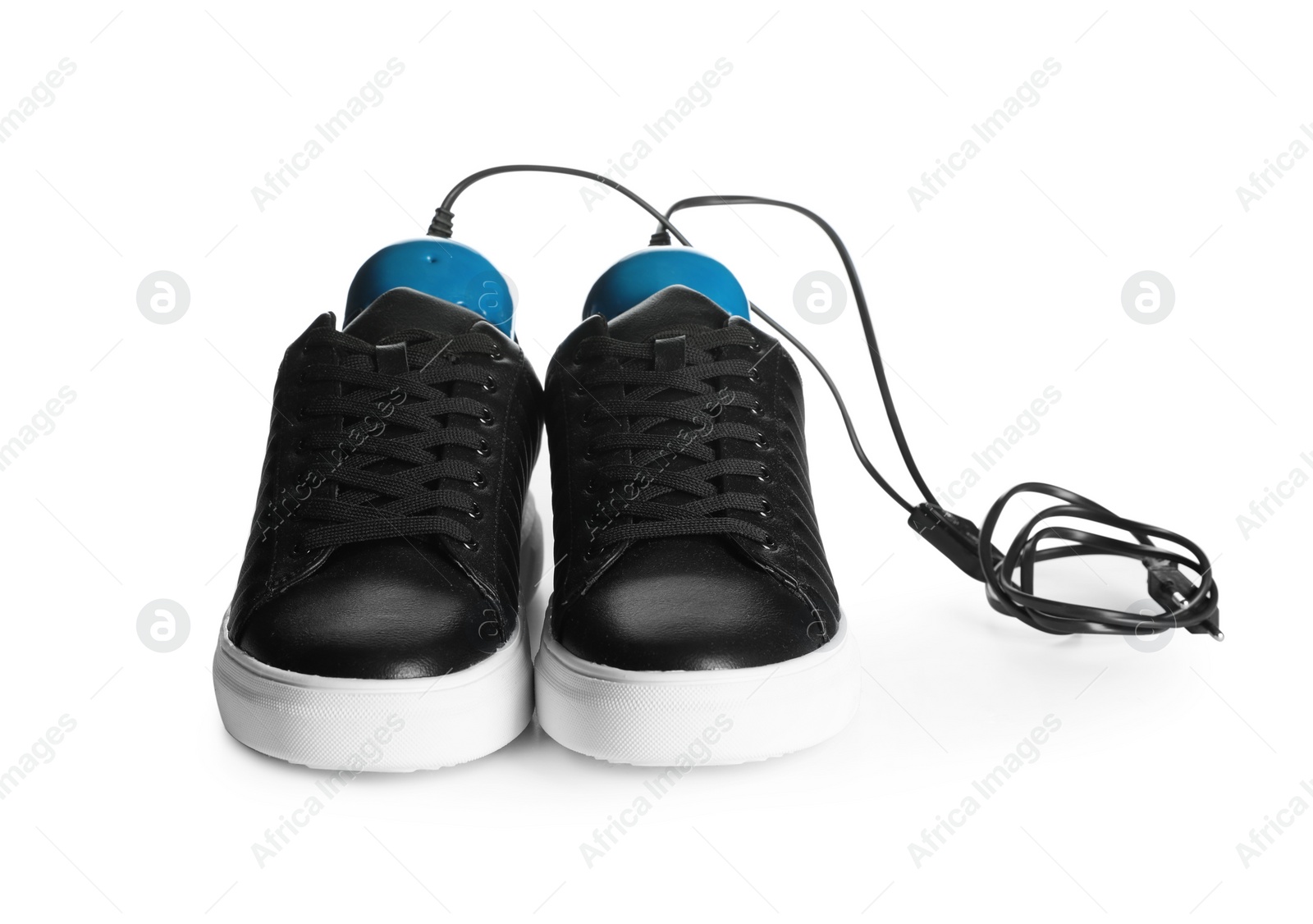 Photo of Pair of stylish shoes with modern electric footwear dryer on white background