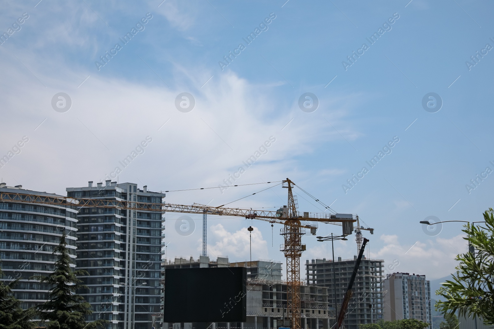 Photo of Construction site with tower cranes near unfinished buildings