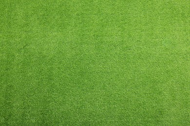 Photo of Green artificial grass as background, top view