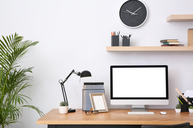 Modern computer on table in office interior. Stylish workplace