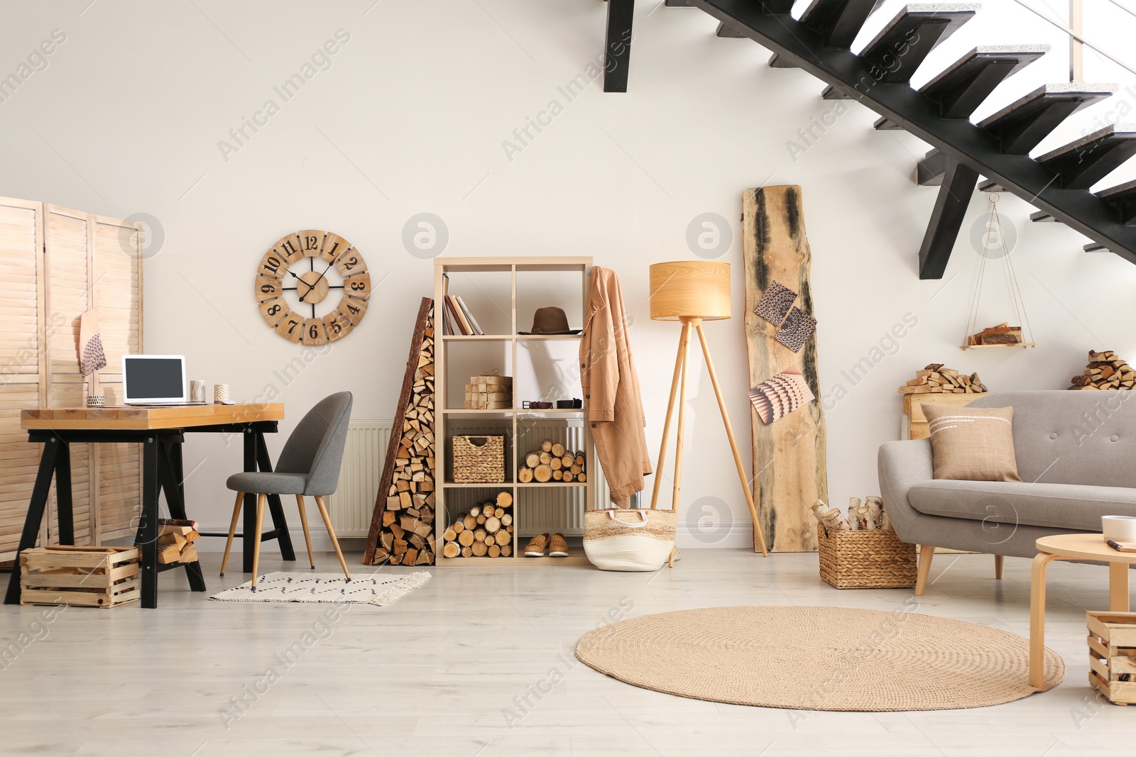 Photo of Stylish room interior with firewood as decorative element