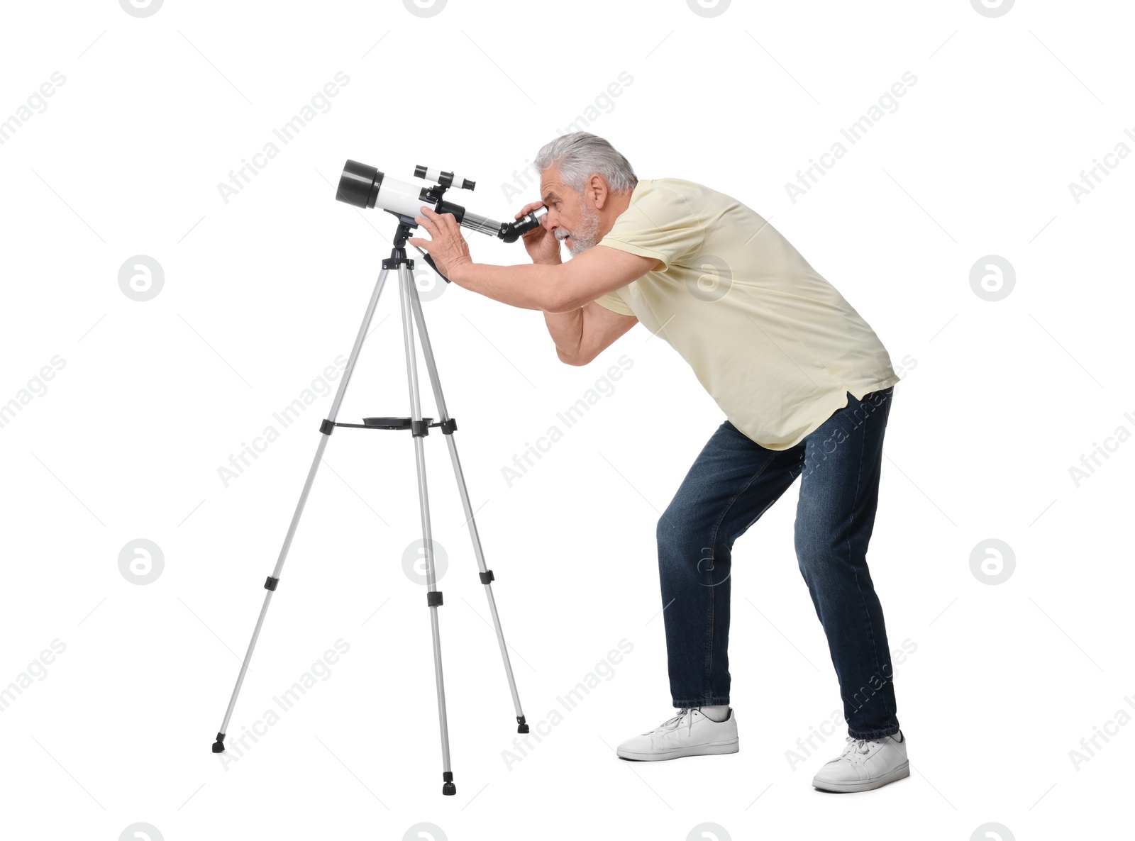 Photo of Senior astronomer looking at stars through telescope on white background