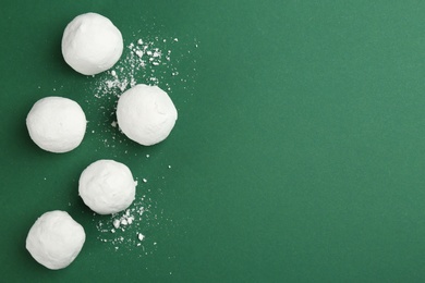 Photo of Snowballs on green background, flat lay. Space for text