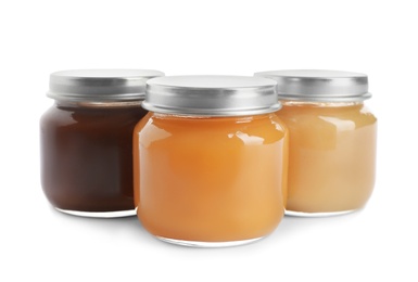 Jars with healthy baby food on white background