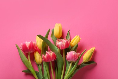 Photo of Many beautiful tulips on pink background, flat lay. Space for text