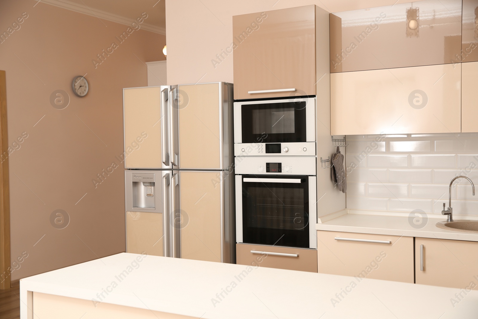 Photo of Interior of spacious modern kitchen with refrigerator