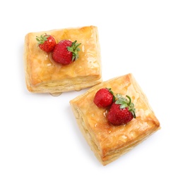 Fresh delicious puff pastry with sweet strawberries on white background, above view