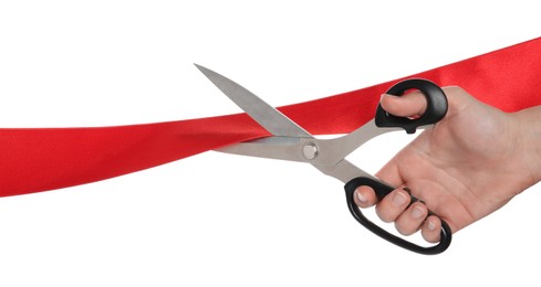 Photo of Woman cutting red ribbon on white background, closeup