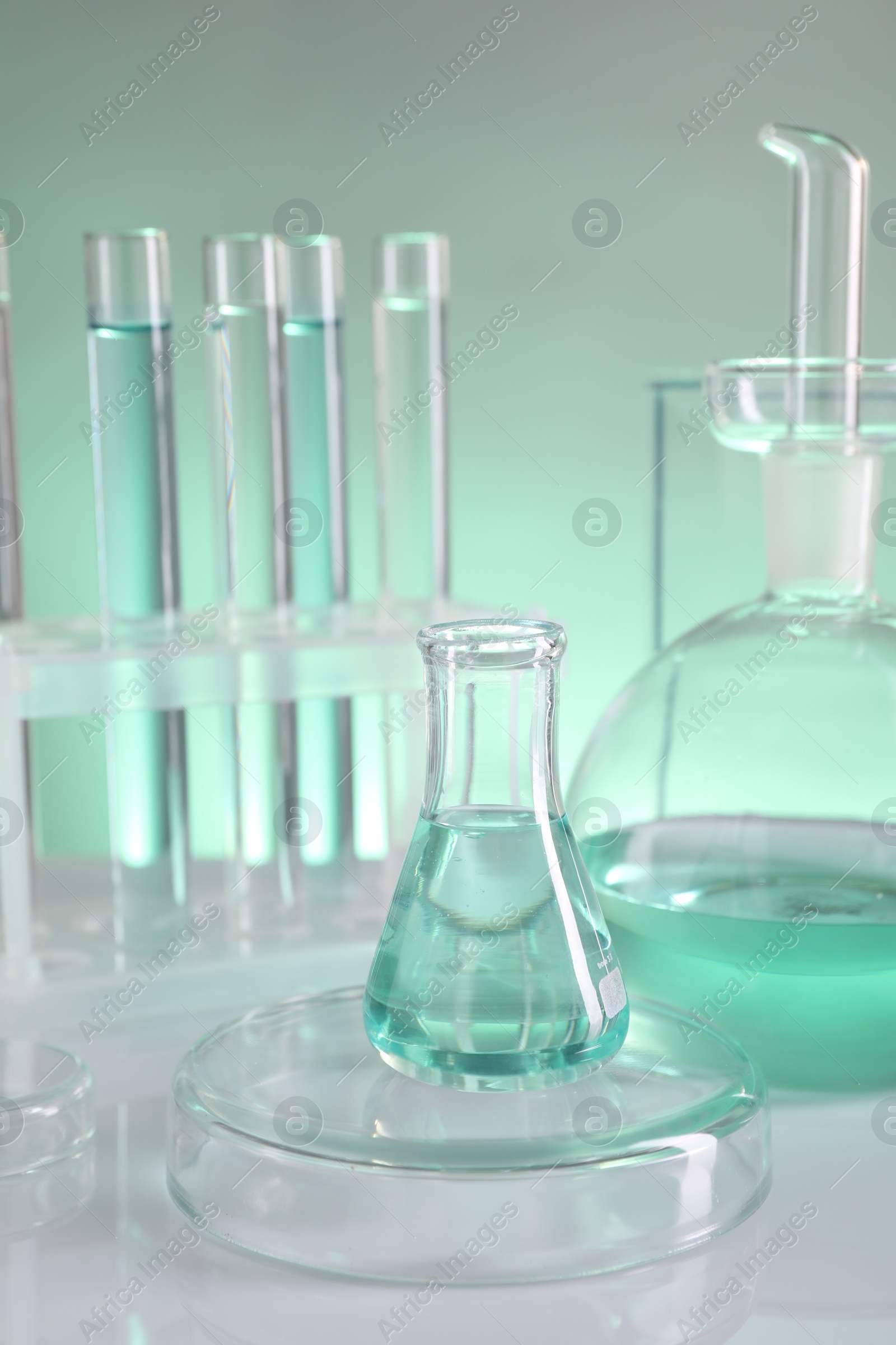 Photo of Laboratory analysis. Different glassware on table against color background