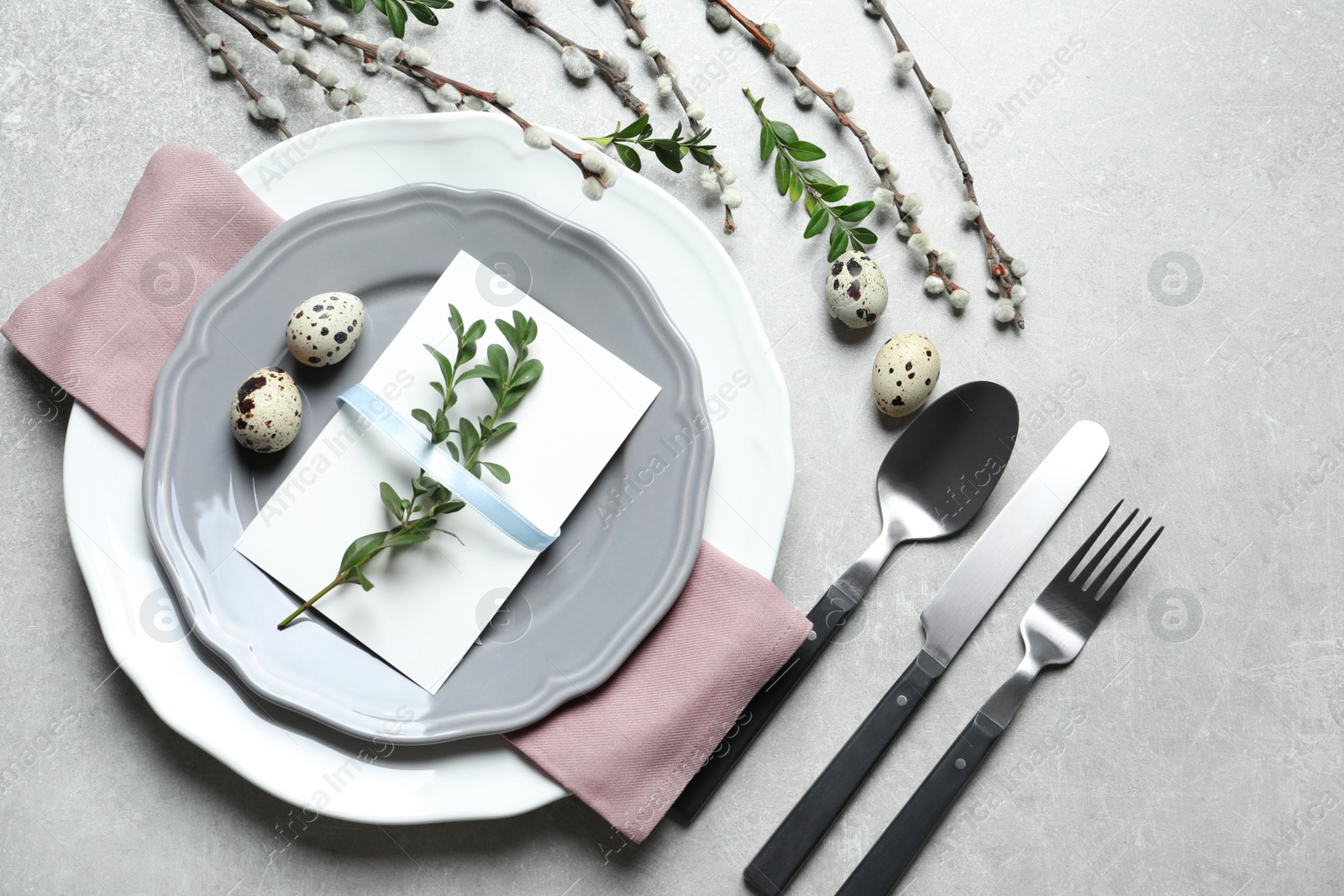 Photo of Festive Easter table setting with quail eggs on color background, flat lay