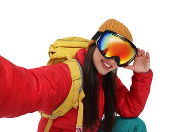 Smiling woman in ski goggles taking selfie on white background