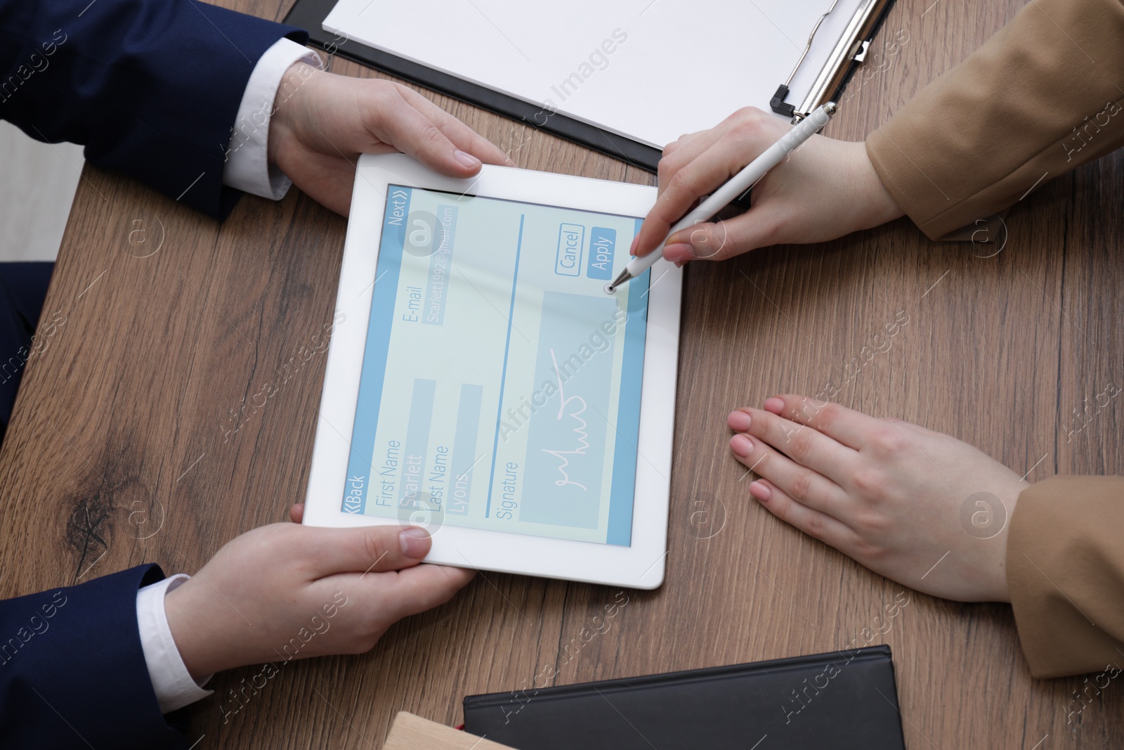 Image of Electronic signature. Woman using stylus and tablet at wooden table, closeup