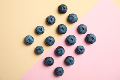 Flat lay composition with tasty blueberry on color background