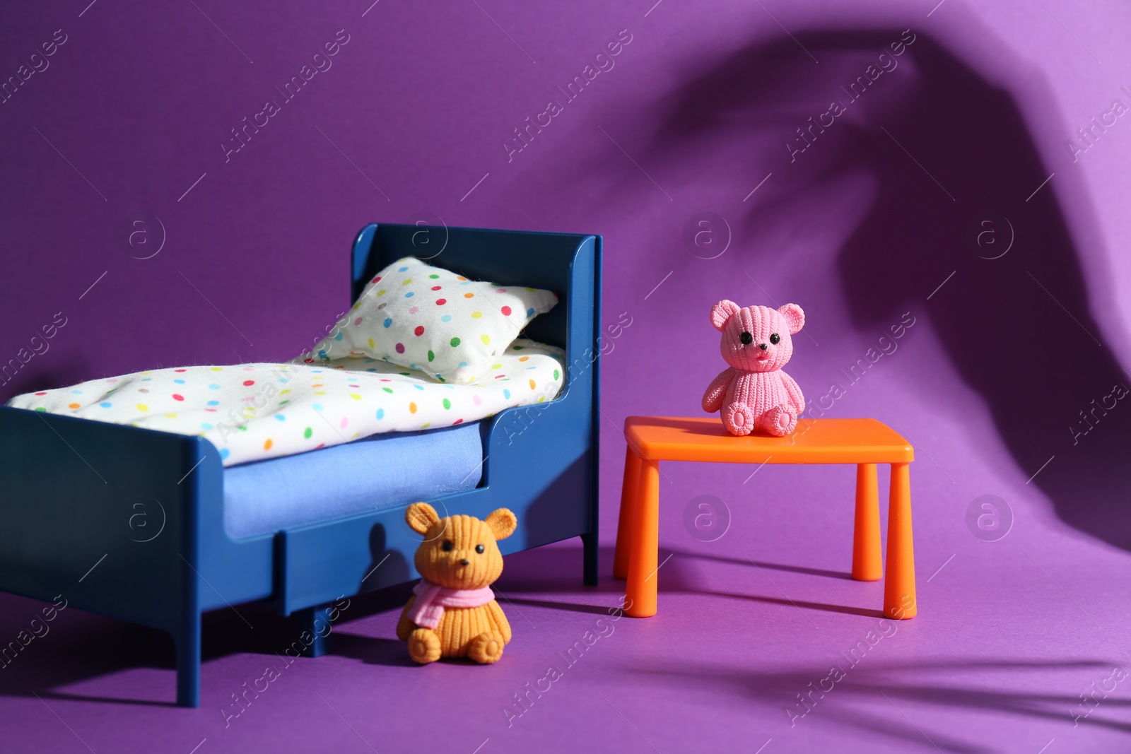 Photo of Stop child abuse. Little toy bears and scary shadow in kid's bedroom