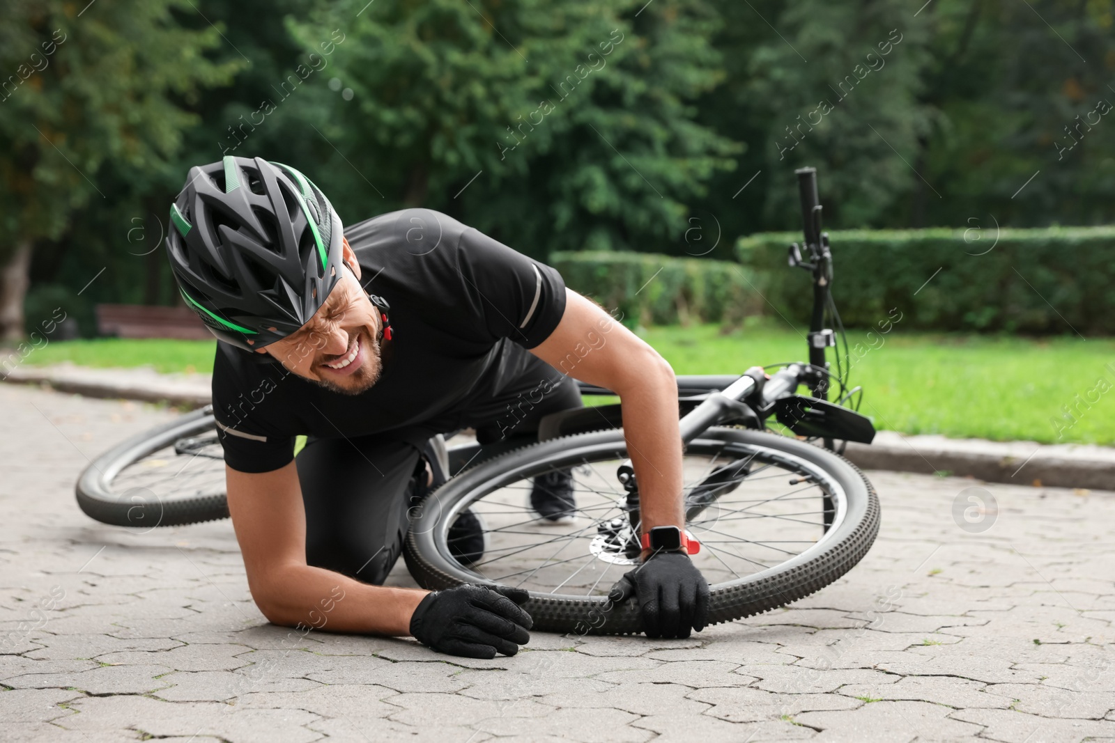 Photo of Man fallen off his bike in park