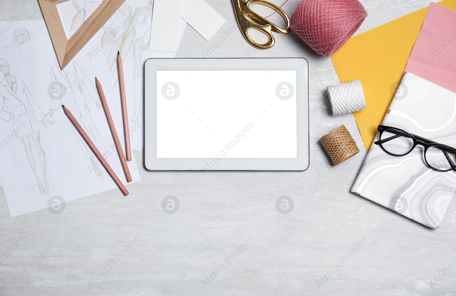 Photo of Flat lay composition with modern tablet and accessories on white table, space for text. Designer's workplace