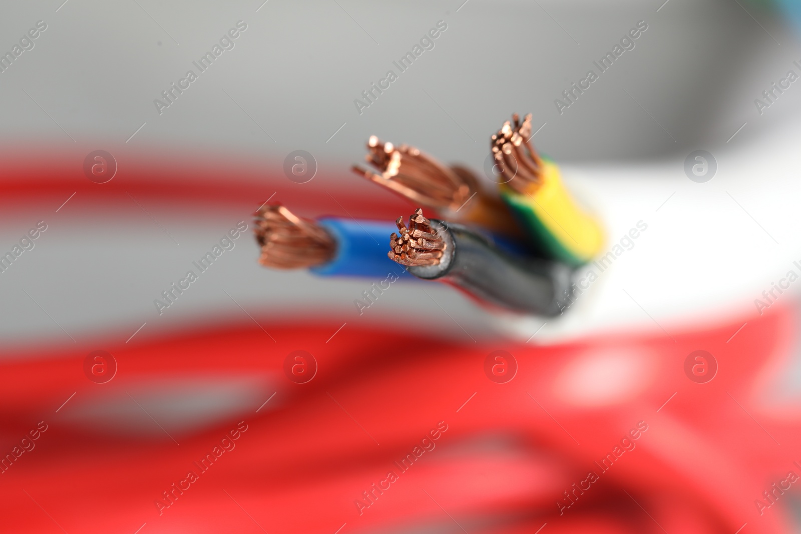 Photo of Colorful electrical wire on blurred background, closeup